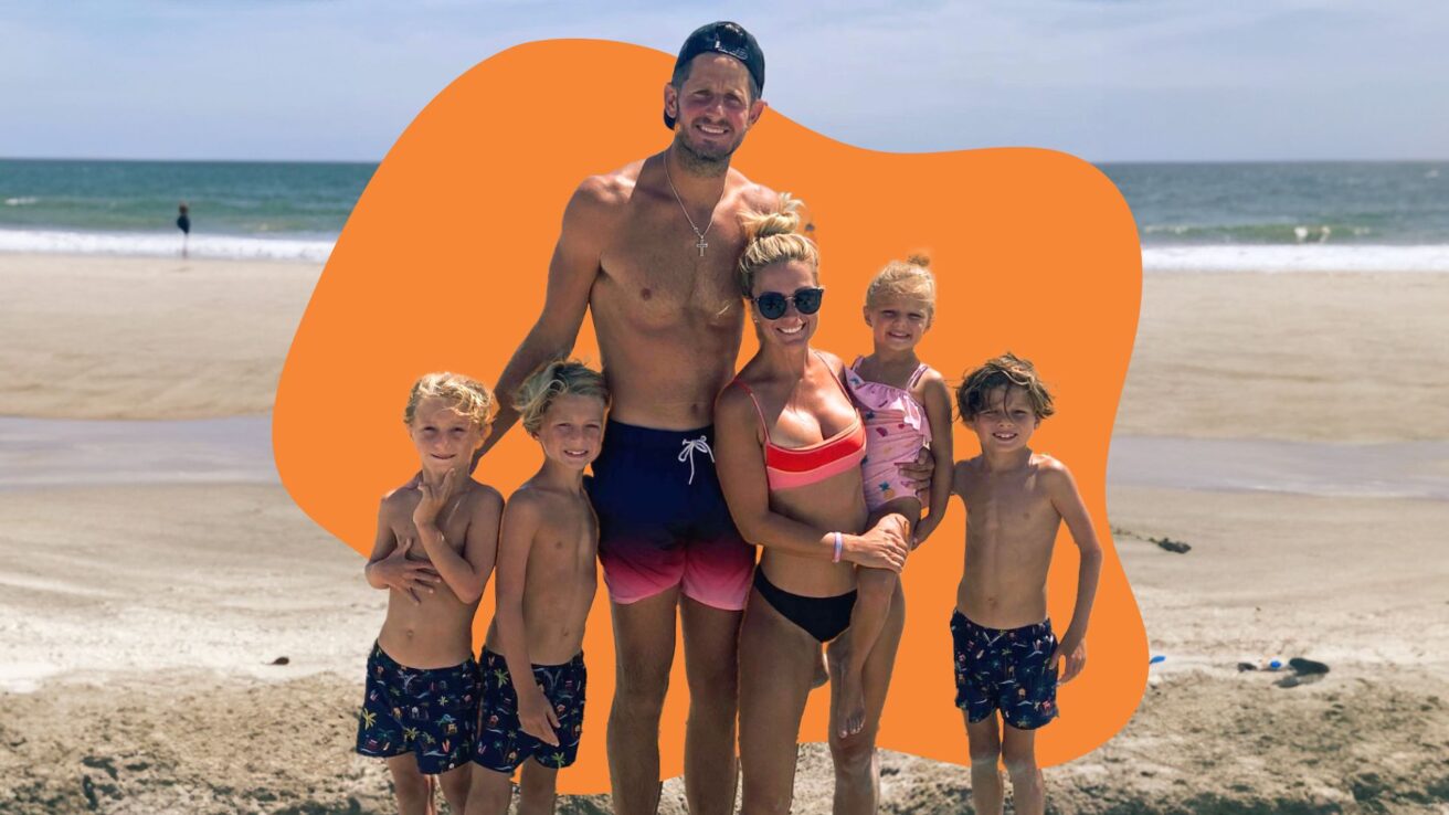 family at the beach in front of an orange shape in background