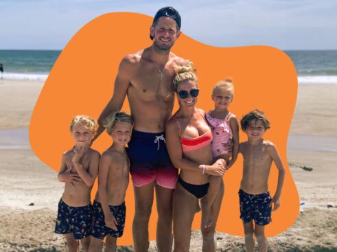 family at the beach in front of an orange shape in background